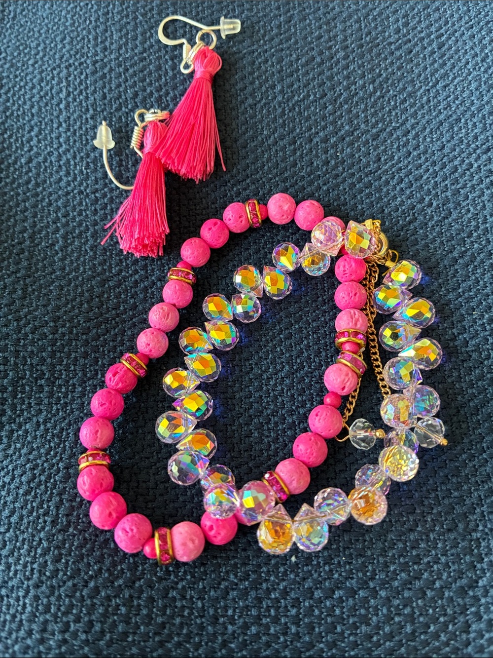 Bright pink lava stone and pink crystal bracelets. Includes tassel earrings.